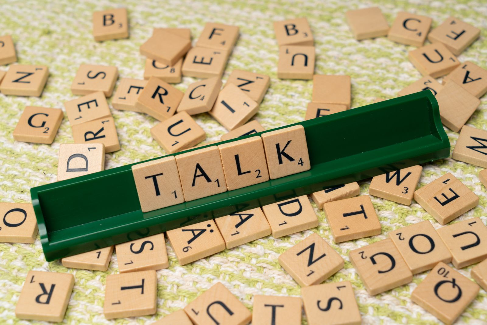 Scrabble tiles spelling TALK — speech and language theme